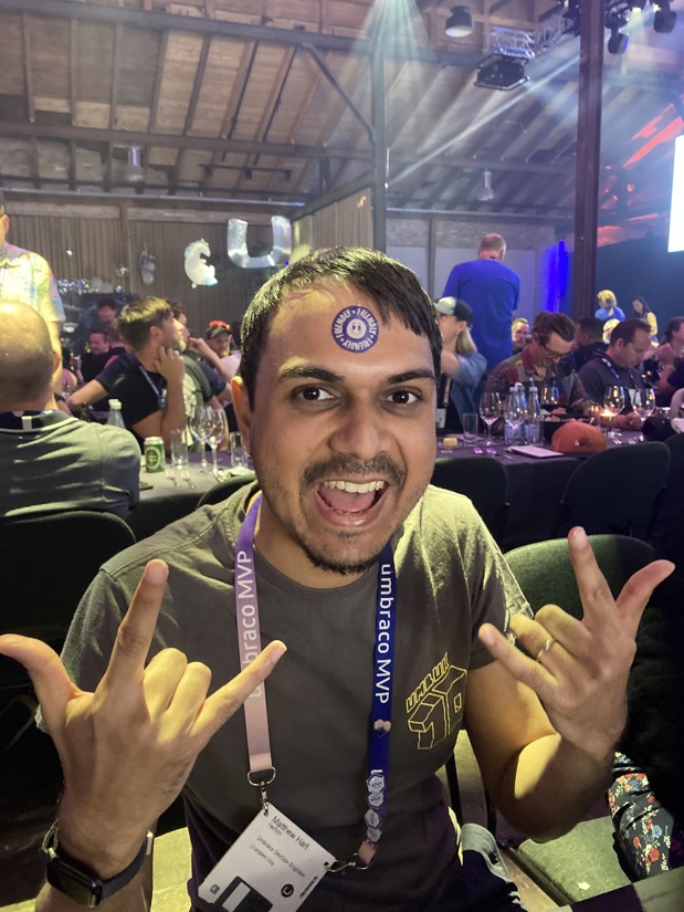 Matthew Hart with a round removable tattoo saying friendly on forehead