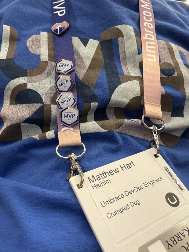 Matthew Harts Floppy disk name badge with Lanyard with 4 MVP pins attached and a heart shaped pin with a mountain summit